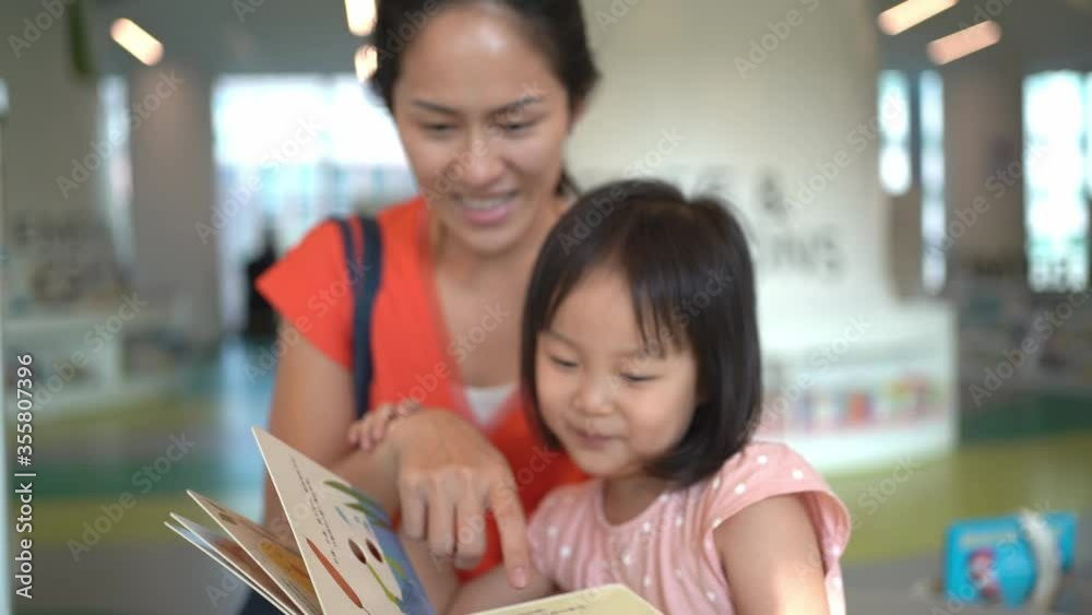 4K Slow Motion of Asian Parent and Child reading at the library 4K Slow Motion of Asian Parent and Child reading at the library