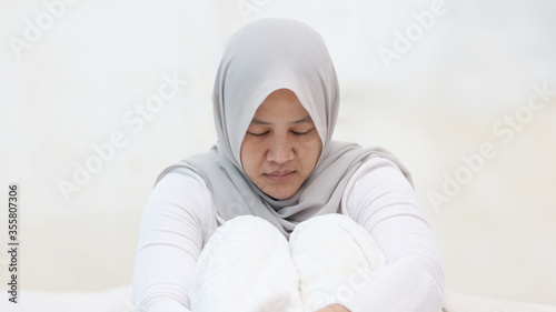 Sad muslim woman crying in sorrow, feeling lonely, depression concept