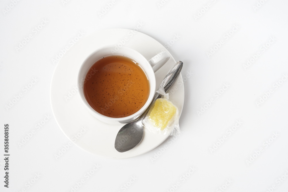 Fototapeta premium Fresh a cup of tea with rock sugar isolated on white