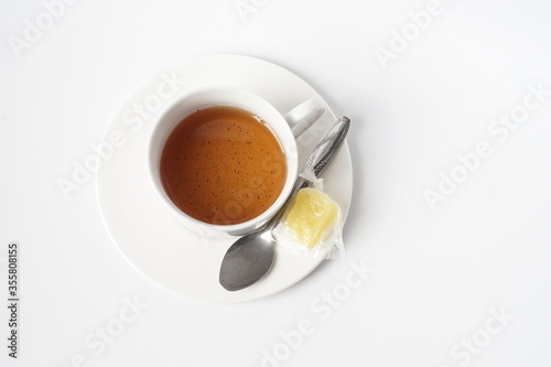 Fresh a cup of tea with rock sugar isolated on white