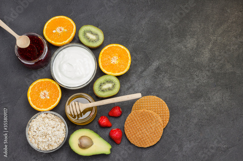 Oatmeal, avocado berries, fruits, jam, yogurt for Energy Healthy breakfast.