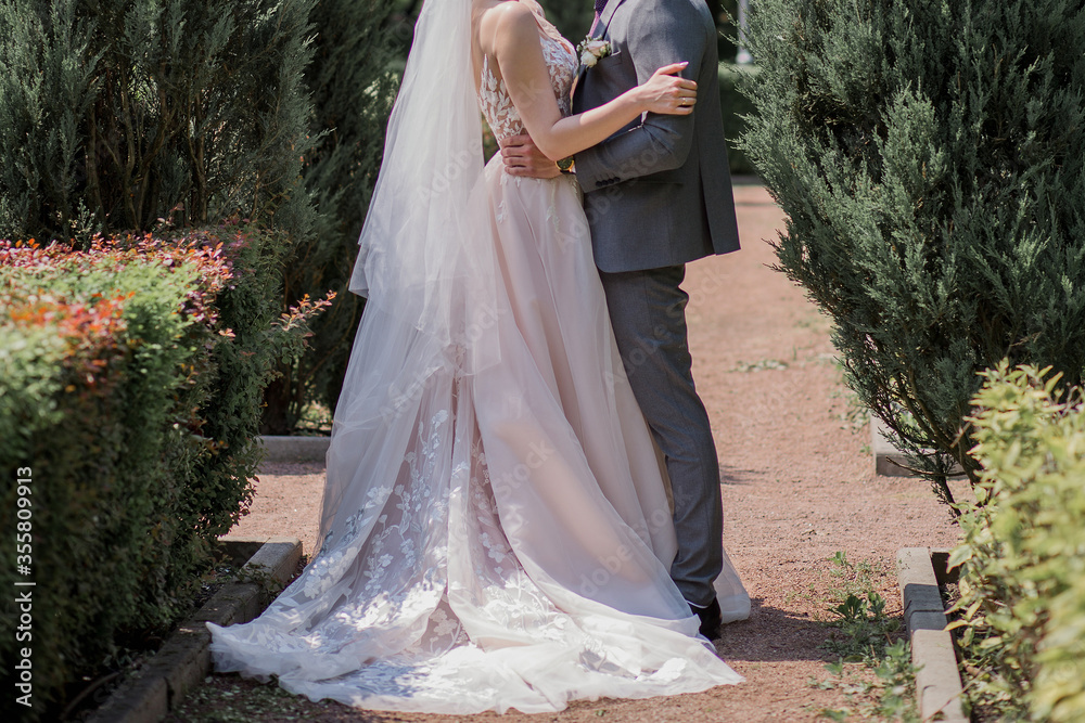 bride and groom in the park together bride and groom in the park together