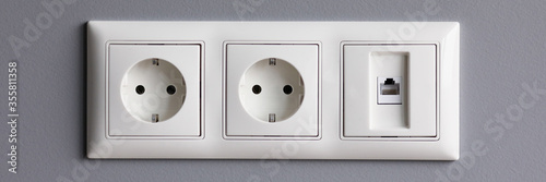 Modern white house outlet on gray wall closeup object