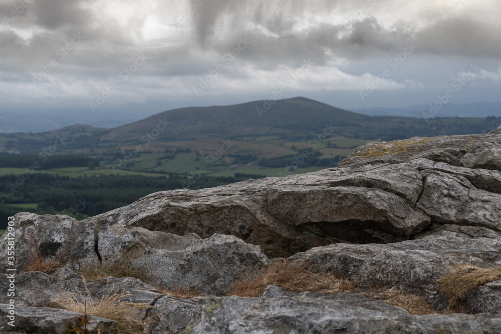 A Welsh mountain viewed from a rock in the Shropshire Hills with dark clouds