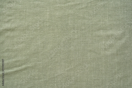 Top view of textile fabric of khaki color as background