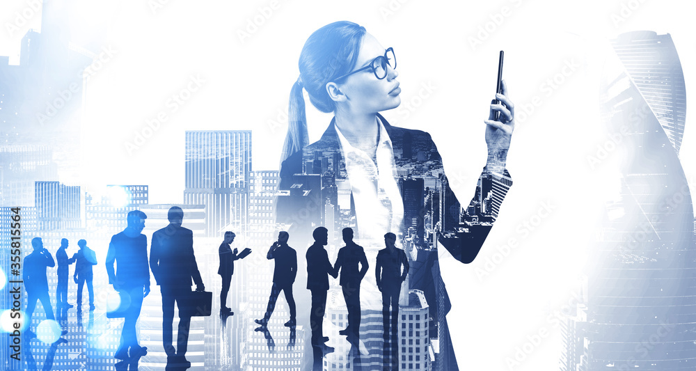 Fotografie Businesswoman with smartphone and her team in city