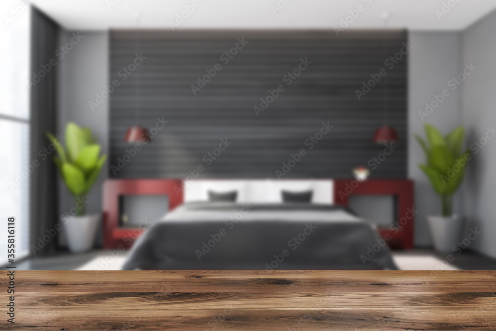 Naklejka premium Table in blurry grey and wooden bedroom