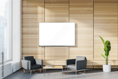 Wooden office waiting room with armchairs and TV