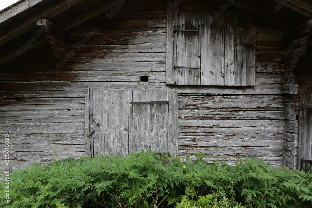 old wooden facade of old house in alps old wooden facade of old house in alps