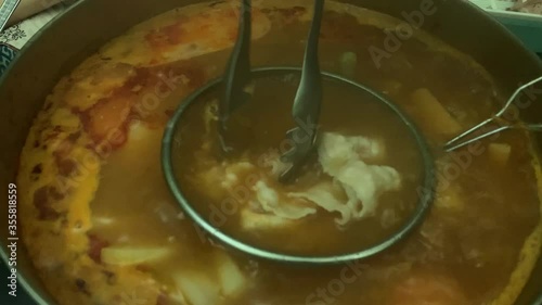 Cooking Pork Slices in Hotpot Steamboat - Chinese Style Hai Di Lao - Tomato Soup Base