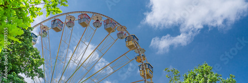 A beautiful old ferris wheel with blue sky background, banner