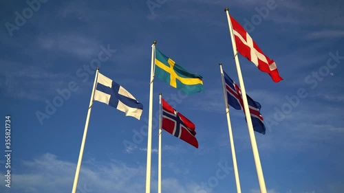 Static shot of scandinavian union flags, swedish, danish, norwegian and icelandic waving in wind on clear sky background