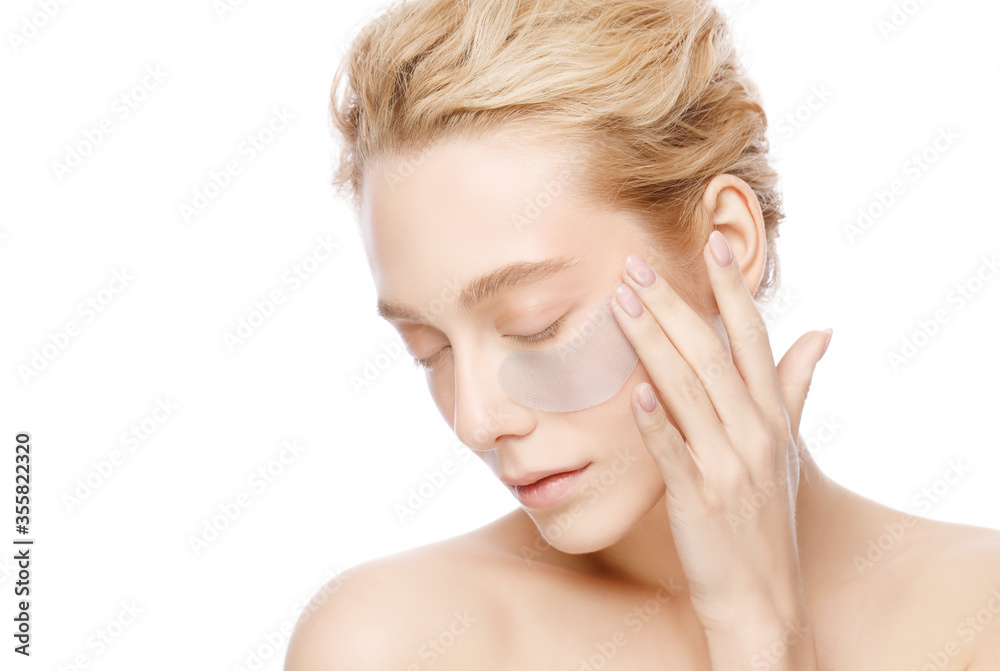 Beautiful woman holding collagen eye patch with one hand, isolated on white background. Perfect clean fresh skin care treatment or cosmetic ads Beautiful woman holding collagen eye patch with one hand, isolated on white background. Perfect clean fresh skin care treatment or cosmetic ads