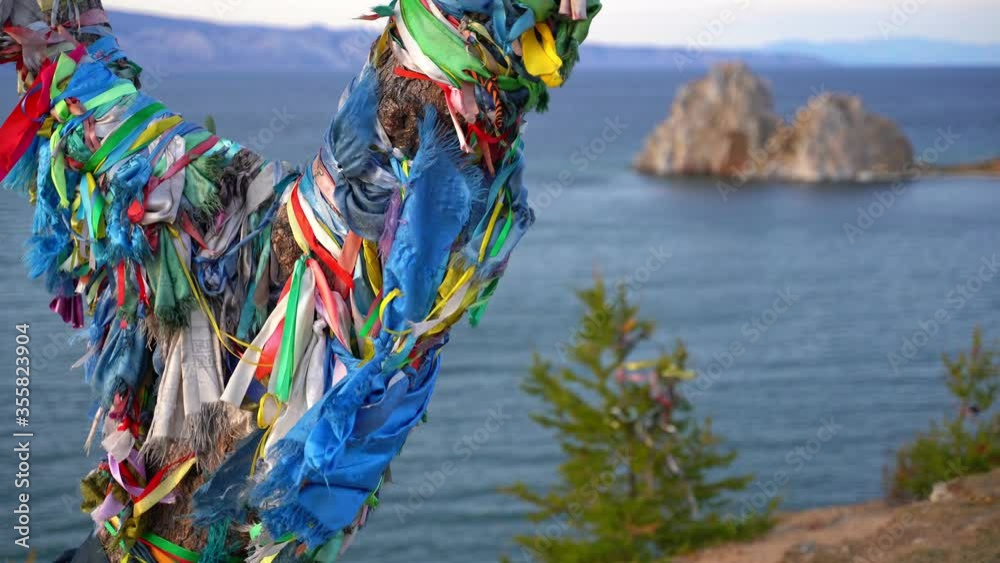 Ritual ribbons on a tree on the Olkhon island in Lale Baikal, Russia Ritual ribbons on a tree on the Olkhon island in Lale Baikal, Russia