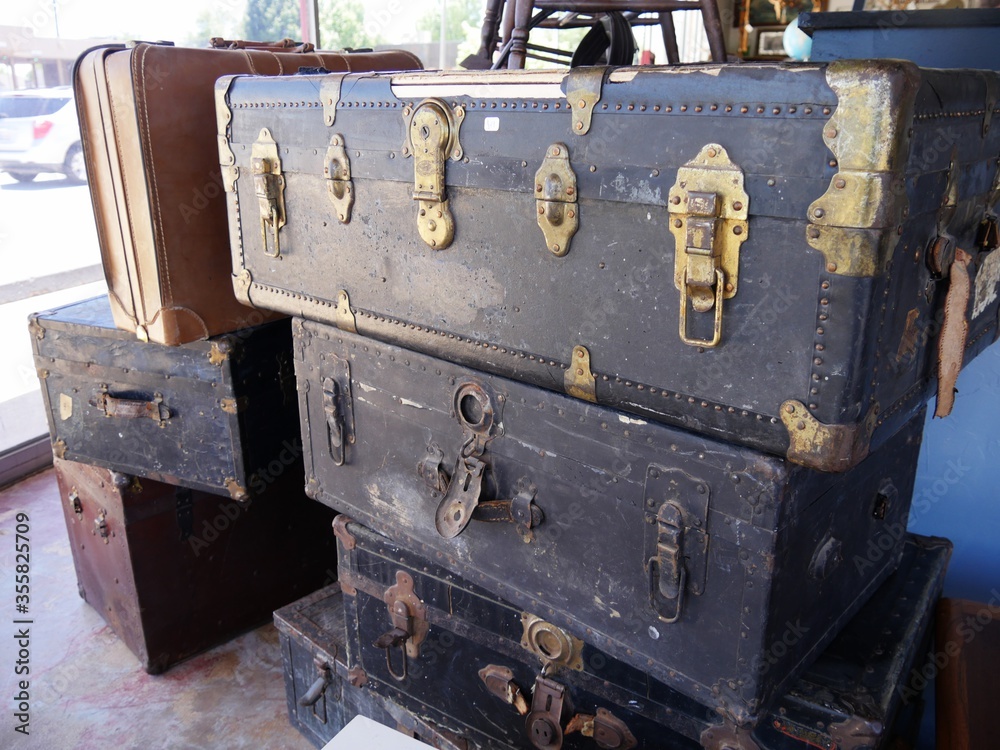 Stack of vintage wooden chests and suitcases with rusty locks