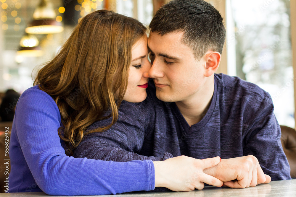 loving man and beautiful young pregnant woman looking at each other outdoors loving man and beautiful young pregnant woman looking at each other outdoors