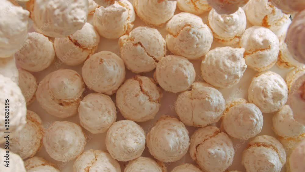 Meringues pastries sweets light pink peach colour table top still life push in down camera movement Meringues pastries sweets light pink peach colour table top still life push in down camera movement