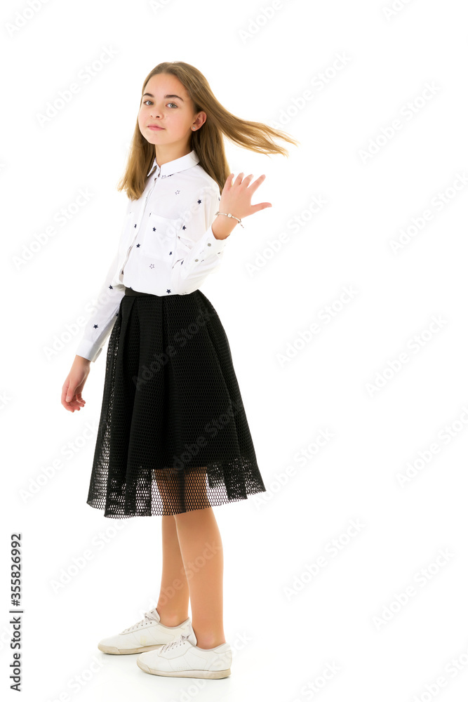 A little girl fixes her hair.The concept of beauty and fashion A little girl fixes her hair.The concept of beauty and fashion