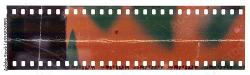 Start of 35mm negative filmstrip, first frame on white background, real scan of film material with cool scanning light interferences and deep scratches.