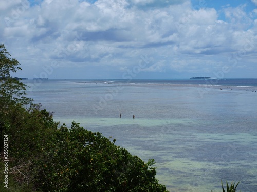 Coastal view of the northern part of Saipan with Managaha Island in the far distance photo