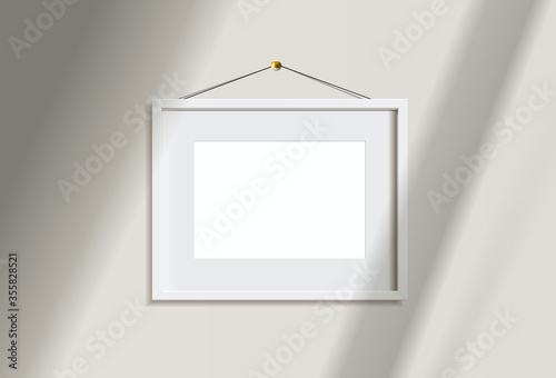 Minimal empty landscape white frame picture mock up hanging on white wall background with window light and shadow. isolate vector illustration.