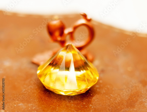 Yellow crystal on a background of bronze candle holder on ceramic plate
