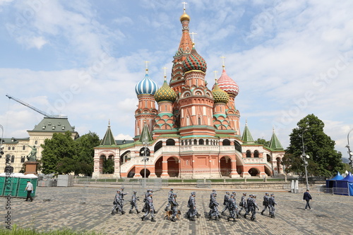 Saint Basil's Cathedral in Kremlin, Moscow city, Russia. Period of self-isolation, coronavirus, covid-19. Policemen in protective masks. Police patrol. Moscow landmark photo