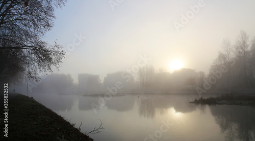 foggy winter sunrise on riverside skyline