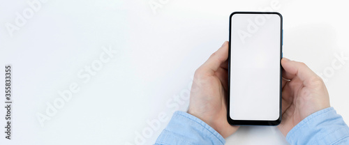 Male hands holding smartphone with blank screen on white background