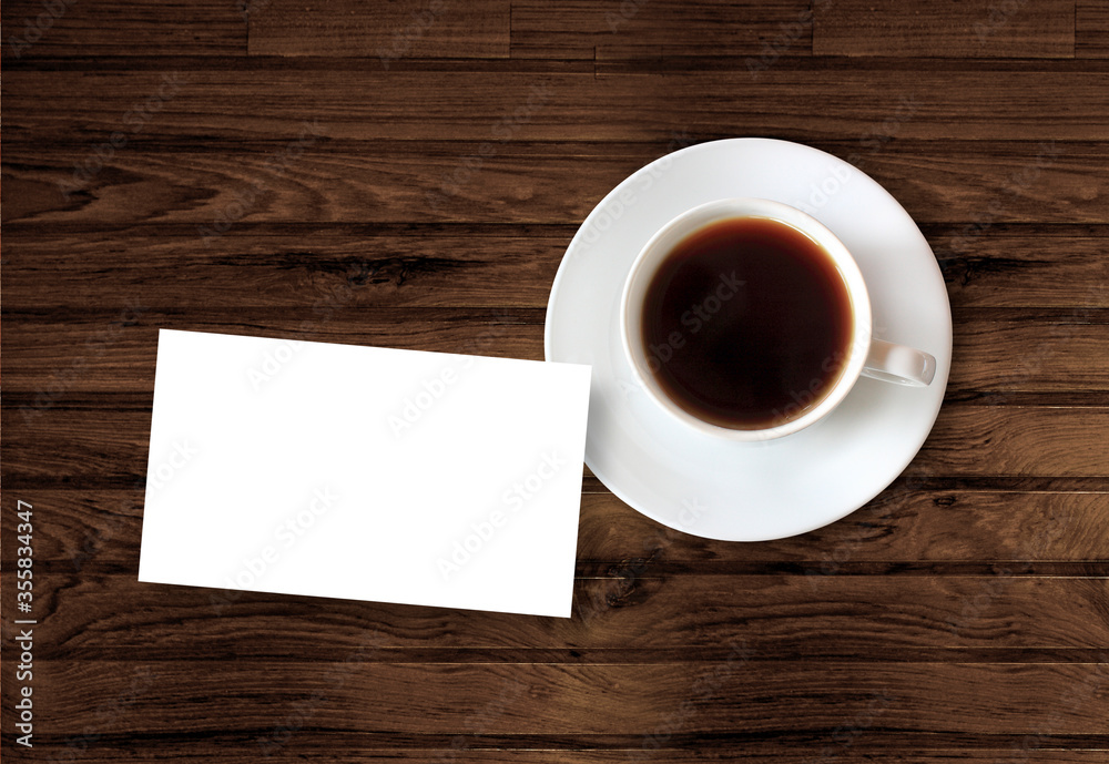 cup of coffee with blank card on wooden table cup of coffee with blank card on wooden table
