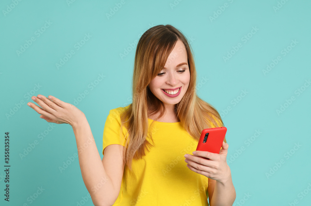 Cheerful young woman using smartphone Cheerful young woman using smartphone