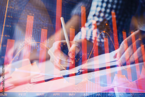 Multi exposure of two men planing investment with stock market forex chart.