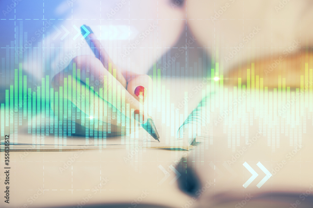 Double exposure of woman's hands making notes with forex graph hologram. Concept stock market analysis. Double exposure of woman's hands making notes with forex graph hologram. Concept stock market analysis.