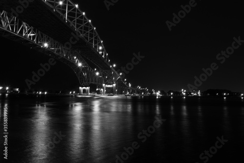  black and white Night image of the Blue Water Bridge from Port Huron crossing over the St. Clare River overlooking Sarnia Ontario Canada  photo
