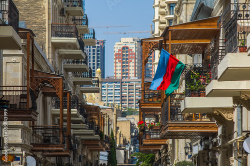 Perspective view of the street with vintage balconies and flag