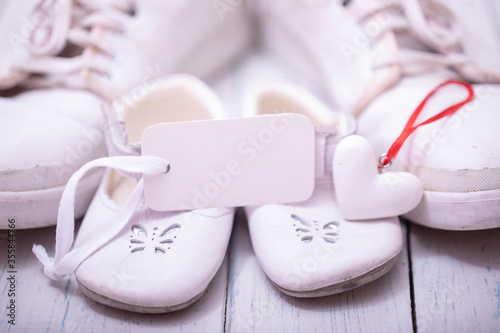 Man's and kid's shoes on white wooden background. Happy father's day concept.