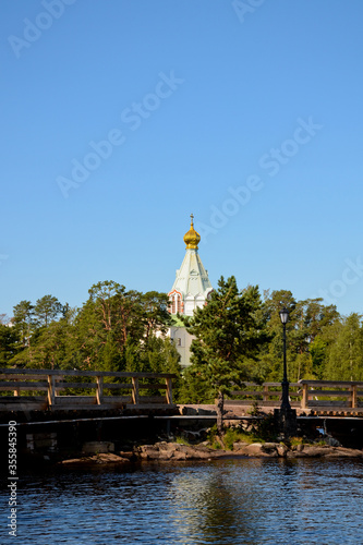 Nikolsky skit on Valaam island as seen from Ladoga lake, vertical photo beautiful nature. Pilgrimage and vacation concept photo