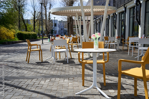 Table and chairs in the outdoor cafe © Andrius