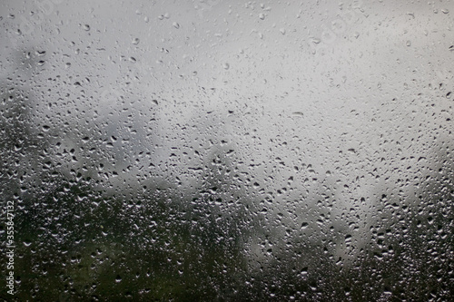 Fotografi raindrops on the window - view out the window outwards, rainy weather, texture b