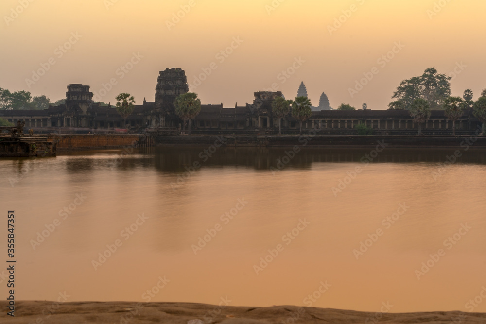 Sunrise view of popular tourist attraction ancient temple complex Angkor Wat with reflected in lake Siem Reap, Cambodia