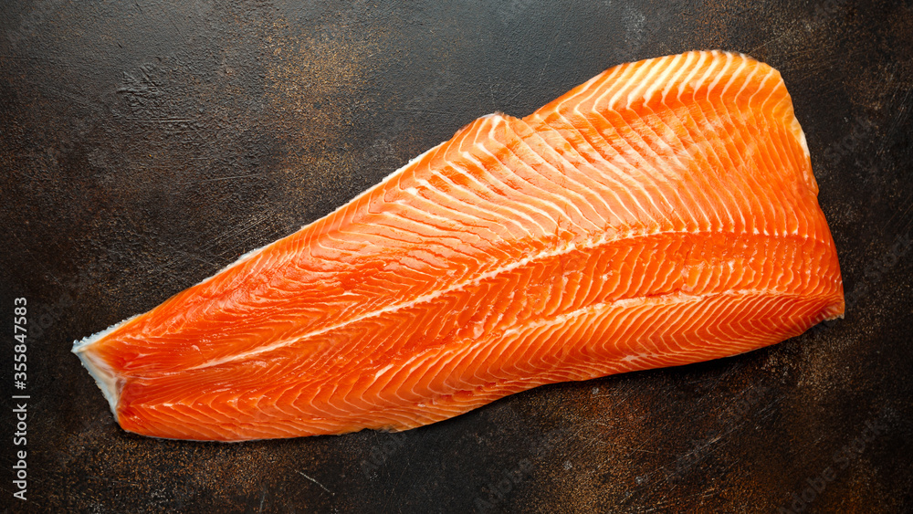 Raw salmon fillet on rustic table background Raw salmon fillet on rustic table background