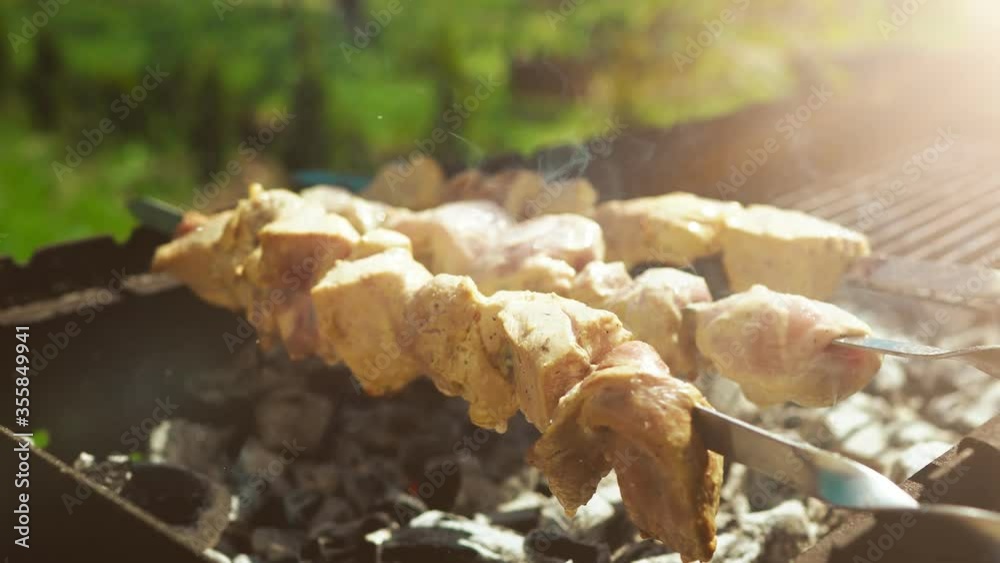 The grill season is open. Pork skewers on backyard. The grill season is open. Pork skewers on backyard.