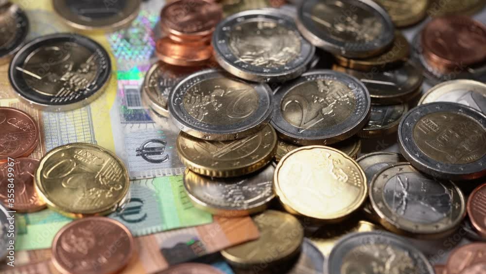 Coins on top of colorful european banknotes. European currency Euro Coins on top of colorful european banknotes. European currency Euro
