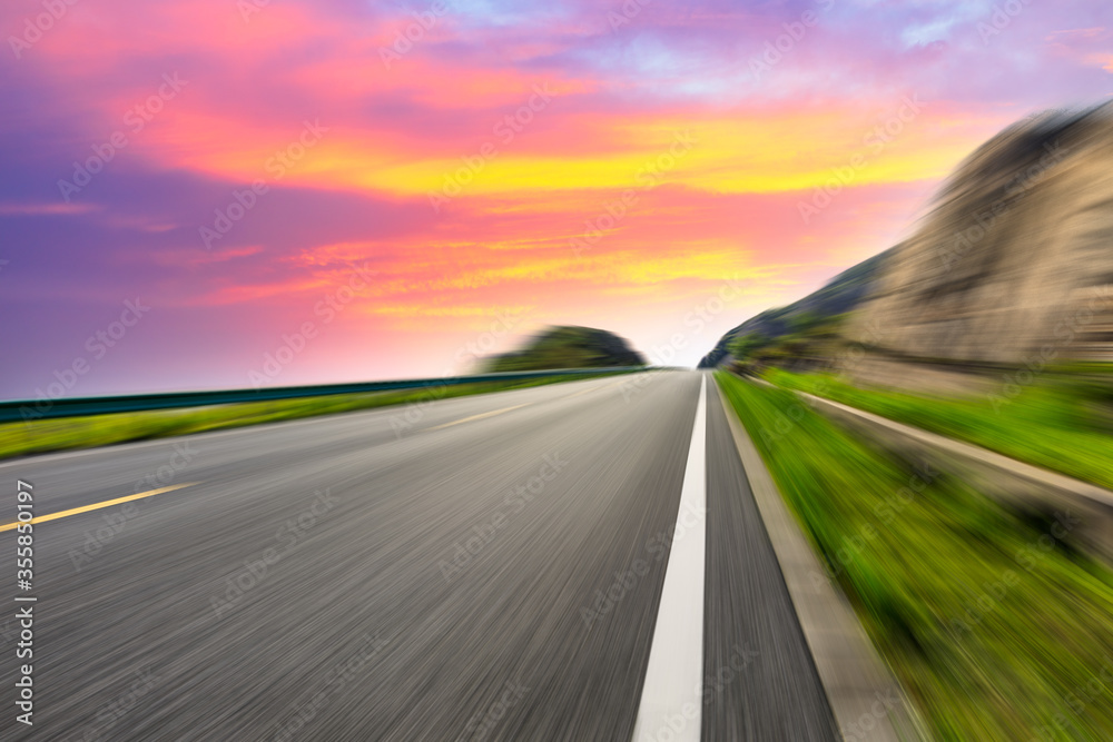 Naklejka premium Motion blurred road and mountains at sunrise.mountain road background.