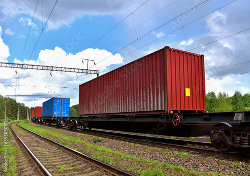 Cargo Containers Transportation On Freight Train By Railway. Intermodal Container On Train Car. Rail Freight Shipping Logistics Concept. Import - export goods from Сhina. Global economy in recession