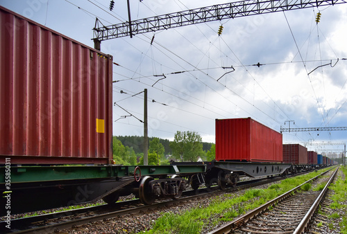 Cargo Containers Transportation On Freight Train By Railway. Intermodal Container On Train Car. Rail Freight Shipping Logistics Concept. Import - export goods from Сhina. Global economy in recession