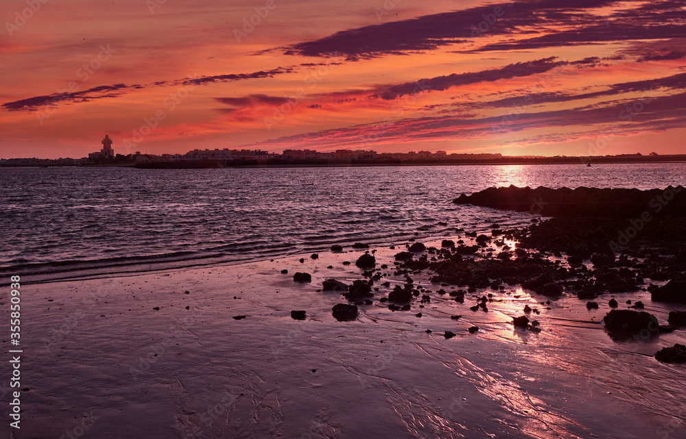 Obraz premium beach sunrise red huelva sea