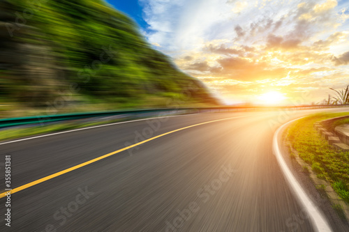 Motion blurred road and mountains at sunrise.mountain road background. © ABCDstock