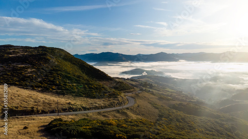 Aerial shot - Scenic view of Road at the peak at Bank Peninsula, Akaroa, New Zealand.