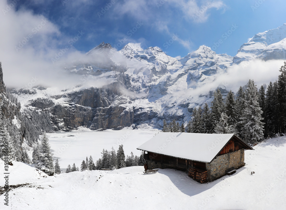 Panoramic winter landscape with frozen lake oeschinen and snow covered mountains, switzerland kandersteg.